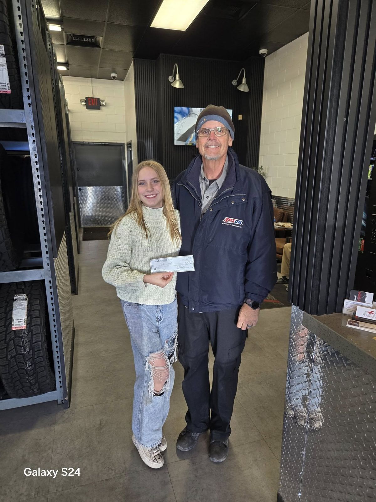 Avery with a local business that sponsored the bike drive (photo 6)